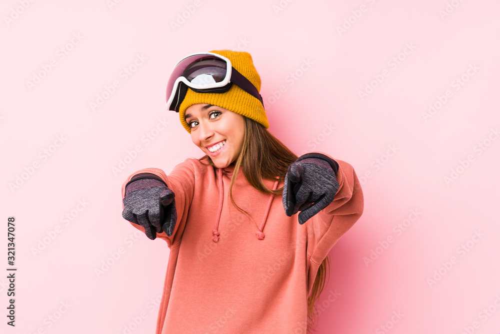 Young caucasian woman wearing a ski clothes isolated cheerful smiles pointing to front. Young caucasian woman wearing a ski clothes isolated cheerful smiles pointing to front.