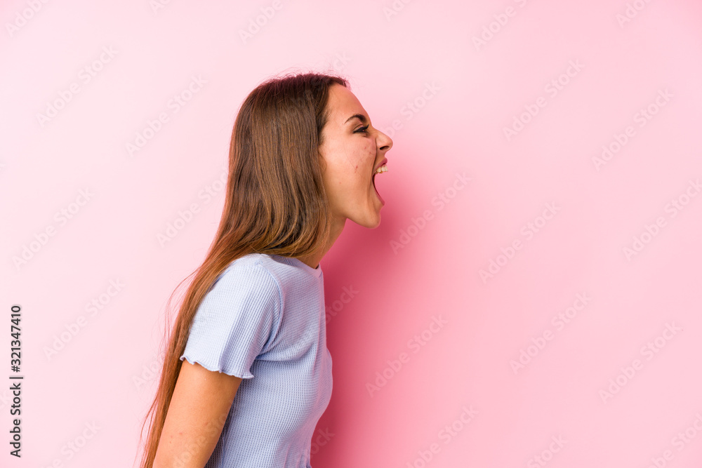 Young caucasian woman wearing a ski clothes isolated shouting towards a copy space Young caucasian woman wearing a ski clothes isolated shouting towards a copy space