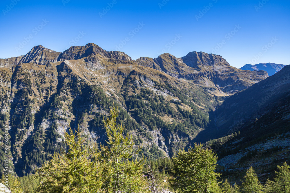 Aerial panorama view of Calanca valley and Swiss Alps in Grisons on the hiking trail from Rifugio Pian Grand to Capanna Buffalora on a sunny summer day , Canton of Graubuenden, Switzerland