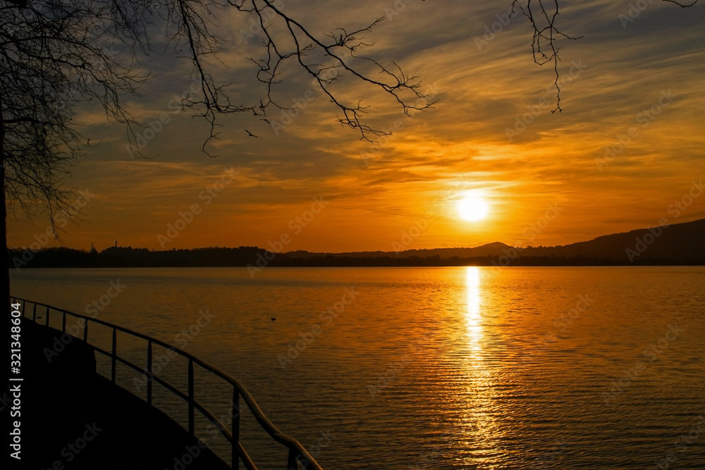 A fiery sunset on lake. Pusiano lake - Italy