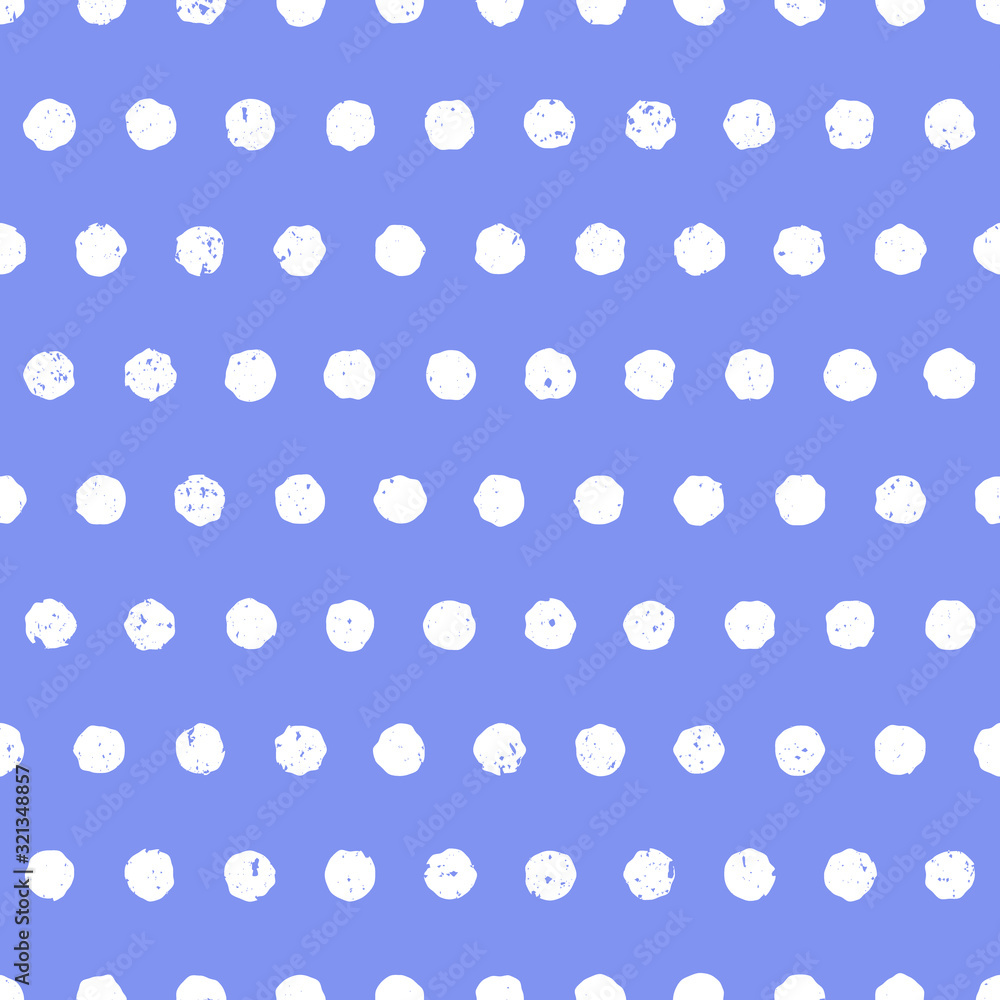 Polka dot white on cornflower blue background. Cute seamless pattern with worn textured effect. Hand drawn style.