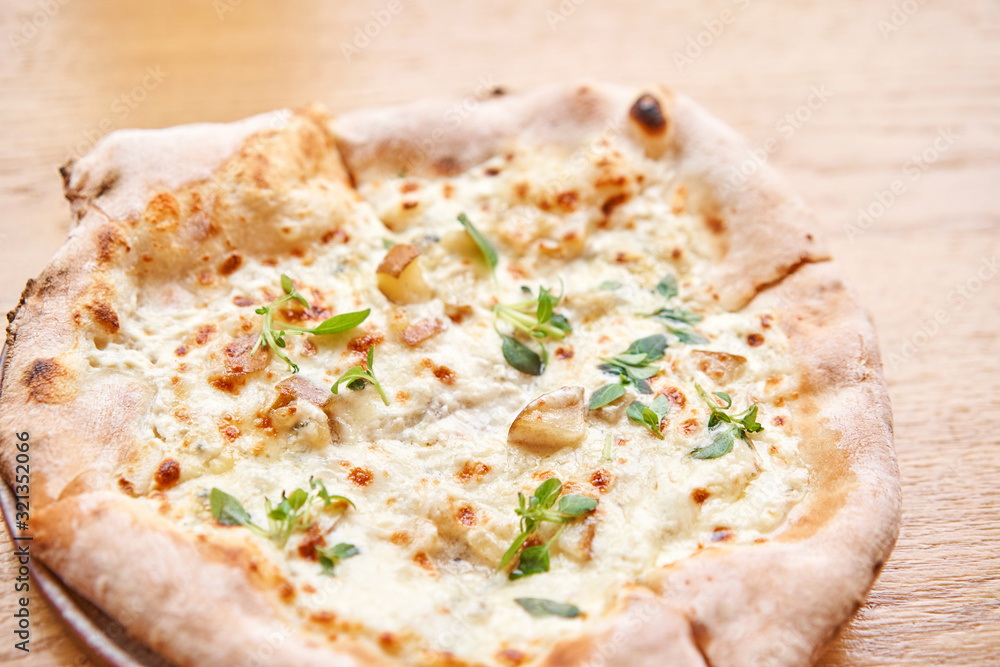 Baked tasty pizza with Gorgonzola and pear, in Traditional wood oven in Naples restaurant, Italy. Original neapolitan pizza. Red hot coal. Baked tasty pizza with Gorgonzola and pear, in Traditional wood oven in Naples restaurant, Italy. Original neapolitan pizza. Red hot coal.