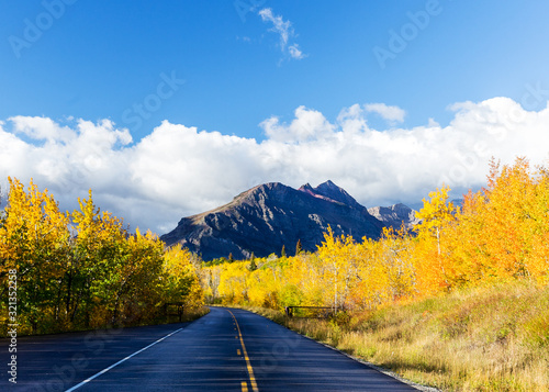 Road going towards mountain near Glacier National Park with bright fall colors