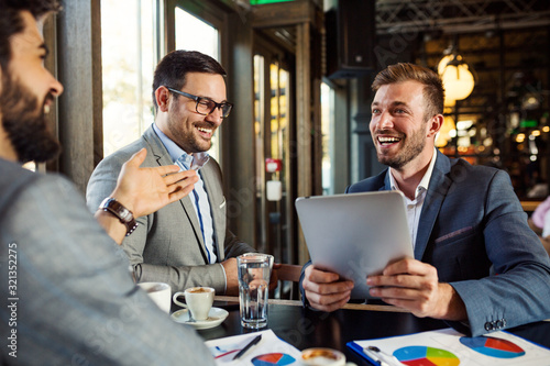 Smiling business people have conversation on coffee break