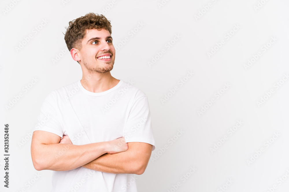 Young blond curly hair caucasian man isolated smiling confident with crossed arms. Young blond curly hair caucasian man isolated smiling confident with crossed arms.