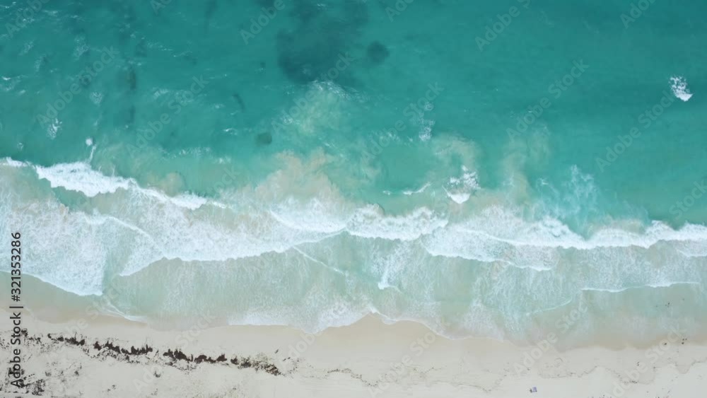 Tropical waves on a white sand beach: 4K Aerial drone footage Tropical waves on a white sand beach: 4K Aerial drone footage