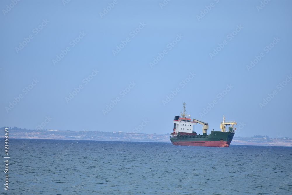 Seascape with a boat in the Mediterranean Sea from Larnaca Cyprus Seascape with a boat in the Mediterranean Sea from Larnaca Cyprus