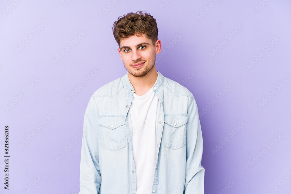 Young blond curly hair caucasian man isolated happy, smiling and cheerful. Young blond curly hair caucasian man isolated happy, smiling and cheerful.