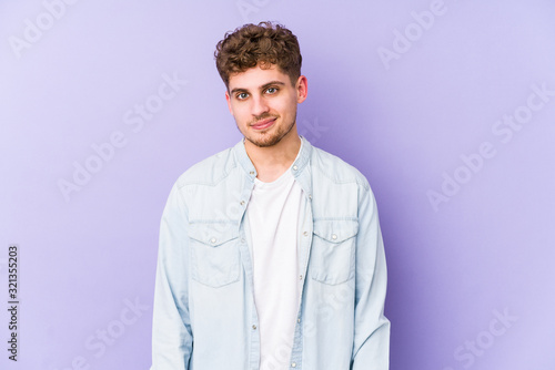 Young blond curly hair caucasian man isolated happy, smiling and cheerful.