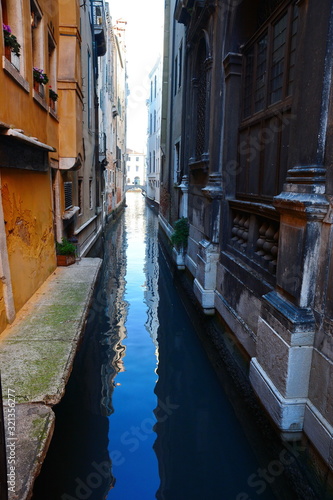 Venice, Italy - January 13, 2020: narrow old streets. Narrow City canals between the buildings.