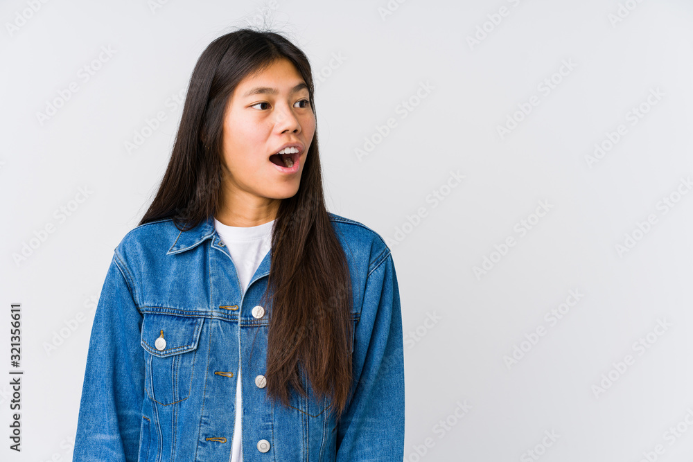 Young asian woman being shocked because of something she has seen.