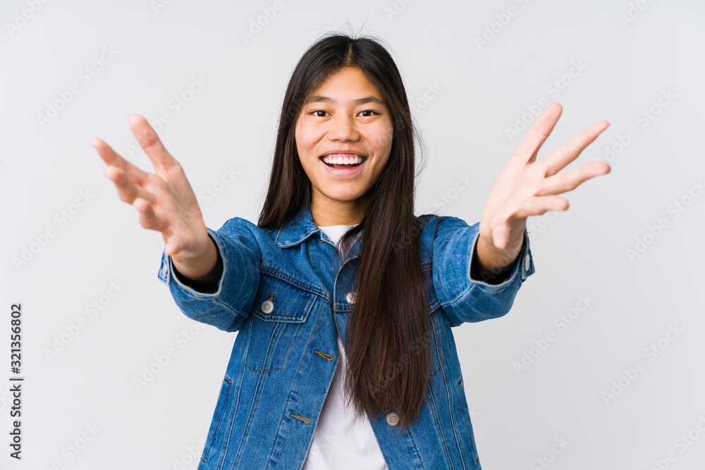 Young asian woman feels confident giving a hug to the camera. Young asian woman feels confident giving a hug to the camera.