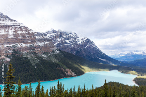 Peyto Lake, a Lake in the Canadian Rockies with glacier blue water on a cloudy day 
