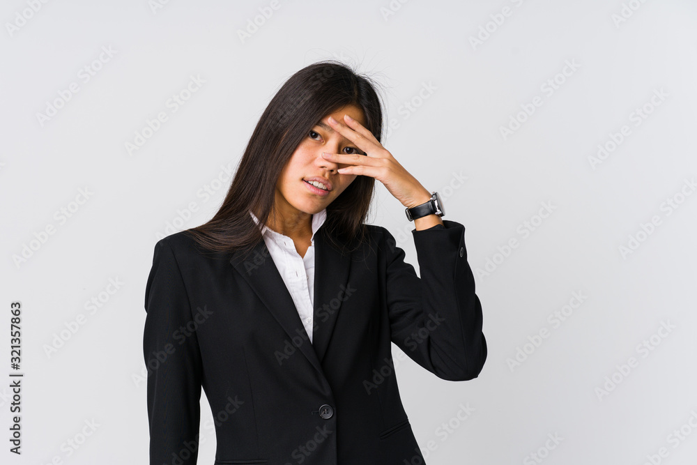 Young asian business woman blink at the camera through fingers, embarrassed covering face. Young asian business woman blink at the camera through fingers, embarrassed covering face.