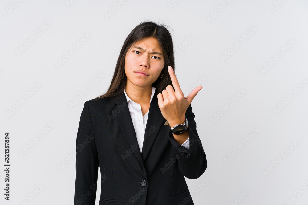 Young asian business woman pointing with finger at you as if inviting come closer. Young asian business woman pointing with finger at you as if inviting come closer.