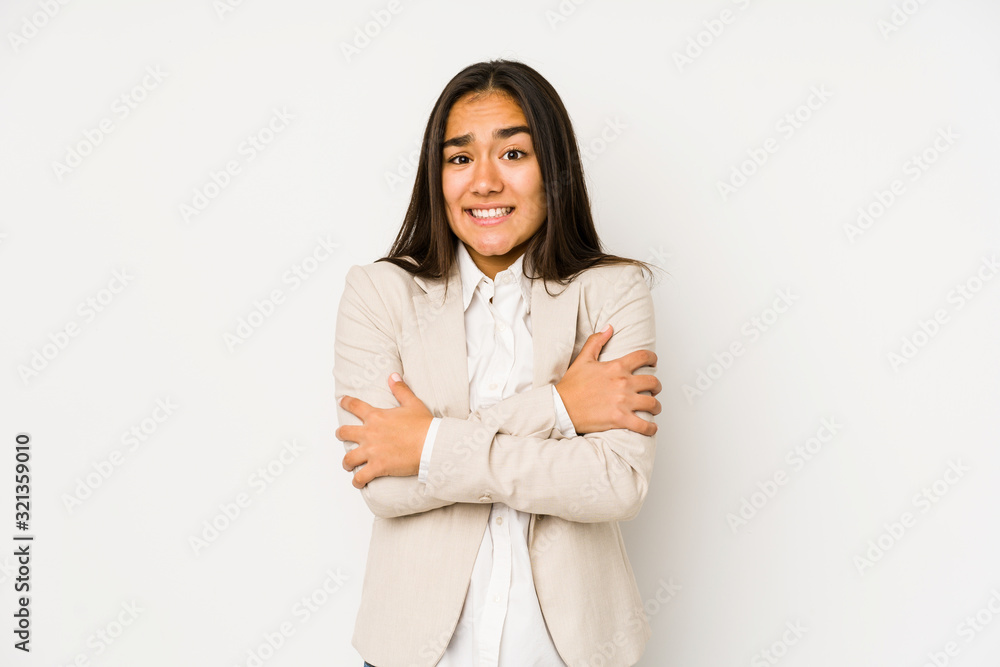 Young woman isolated on a white background going cold due to low temperature or a sickness. Young woman isolated on a white background going cold due to low temperature or a sickness.