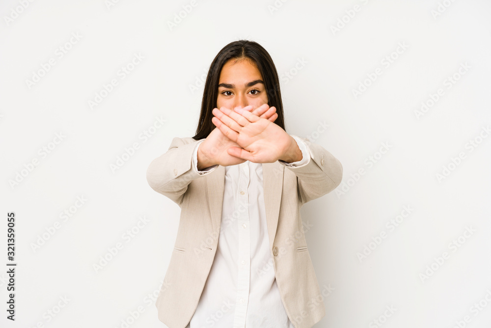 Young woman isolated on a white background doing a denial gesture Young woman isolated on a white background doing a denial gesture