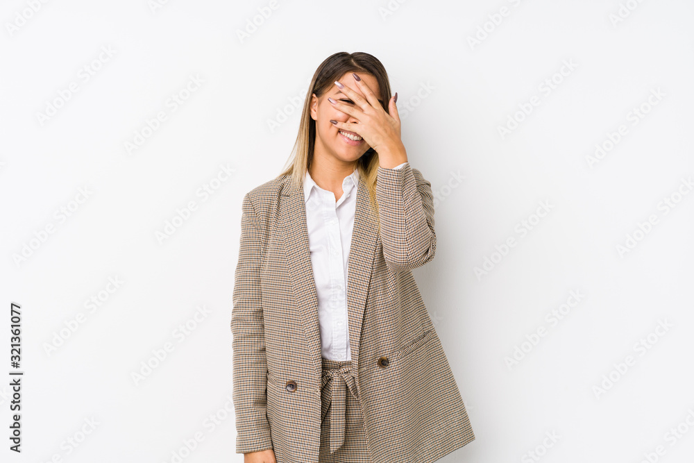 Young caucasian business woman isolated blink at the camera through fingers, embarrassed covering face. Young caucasian business woman isolated blink at the camera through fingers, embarrassed covering face.