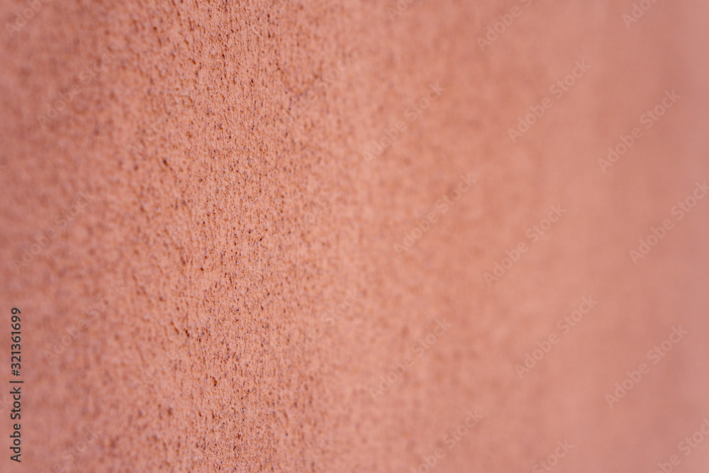 Fototapeta premium Empty background. Orange wall, porous texture. Soft focus.