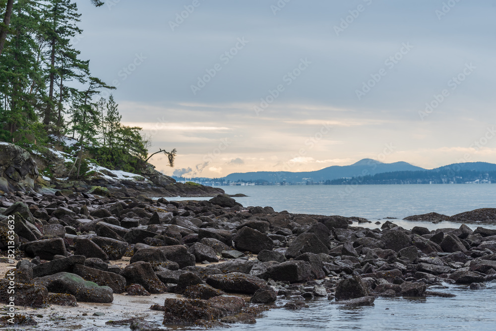 Landscape of Pacific Ocean, rocky shoreline and islands in the distance at Chuckanut Bay in Washington