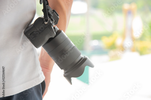 photographer hold camra dslr ,Man doing photography business selling images online photo