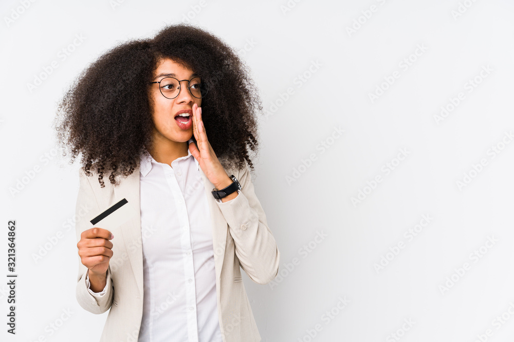 Young afro business woman holding a credit car isolated Young afro business woman holding a credit caris saying a secret hot braking news and looking aside Young afro business woman holding a credit car isolated Young afro business woman holding a credit caris saying a secret hot braking news and looking aside