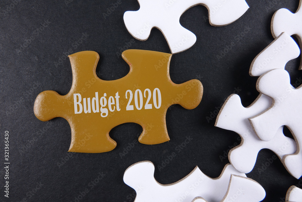 Fototapeta premium Budget 2020 printed on gold puzzle over white puzzle background