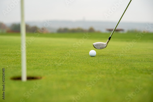 golf game on green course with ball and stick