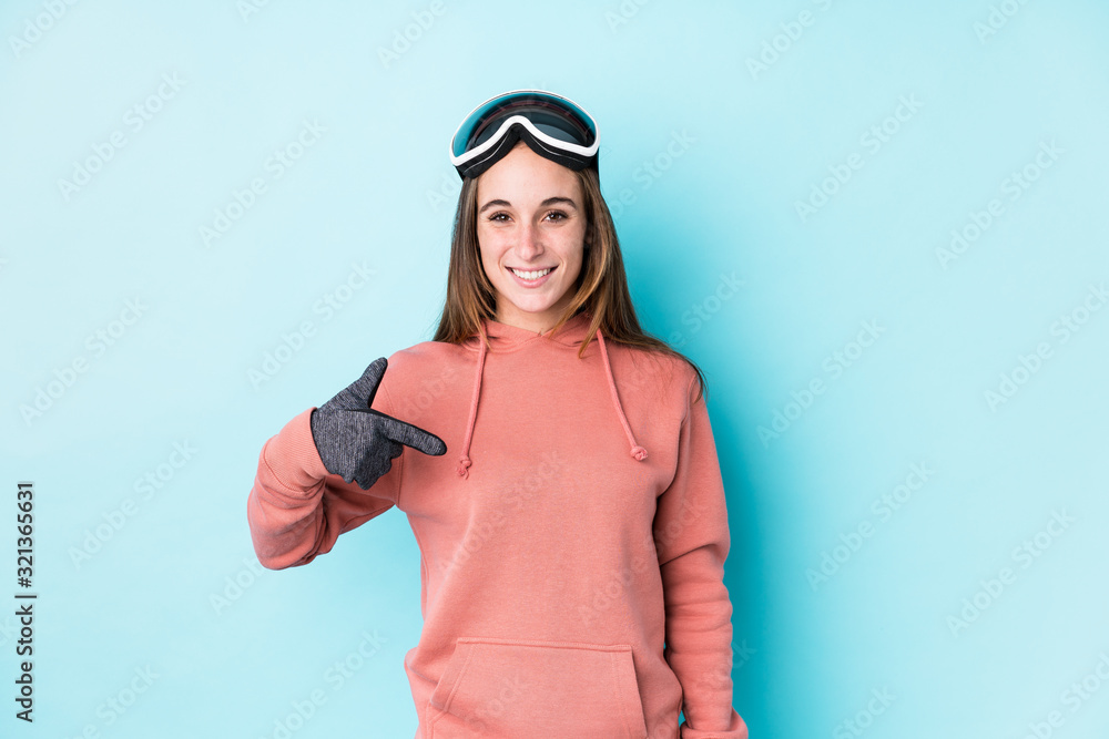 Young skier woman isolated person pointing by hand to a shirt copy space, proud and confident Young skier woman isolated person pointing by hand to a shirt copy space, proud and confident