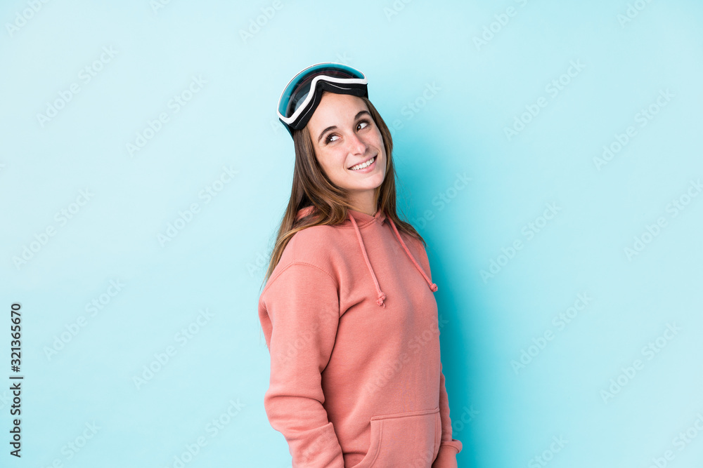 Young skier woman isolated looks aside smiling, cheerful and pleasant. Young skier woman isolated looks aside smiling, cheerful and pleasant.