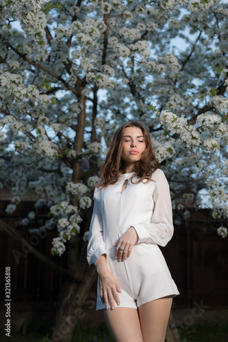 Portrait of beautiful young girl in summer garden.