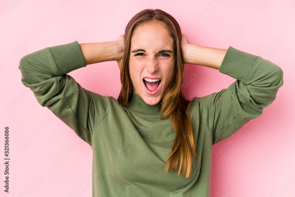 Young caucasian woman posing isolated covering ears with hands trying not to hear too loud sound. Young caucasian woman posing isolated covering ears with hands trying not to hear too loud sound.
