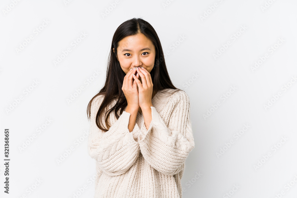 Young chinese woman isolated laughing about something, covering mouth with hands. Young chinese woman isolated laughing about something, covering mouth with hands.