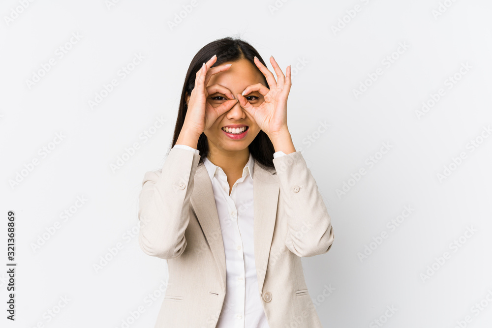Young chinese business woman isolated showing okay sign over eyes Young chinese business woman isolated showing okay sign over eyes