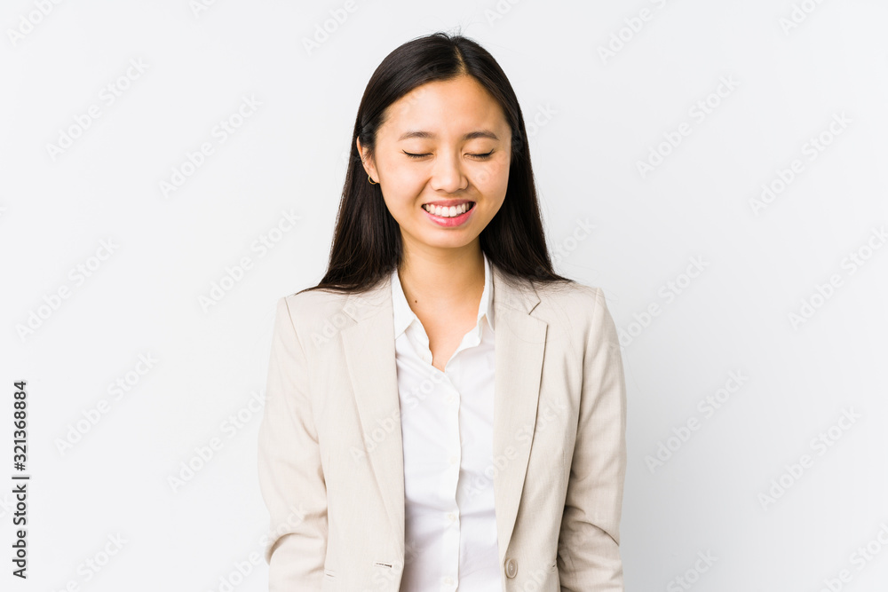 Young chinese business woman isolated laughs and closes eyes, feels relaxed and happy. Young chinese business woman isolated laughs and closes eyes, feels relaxed and happy.