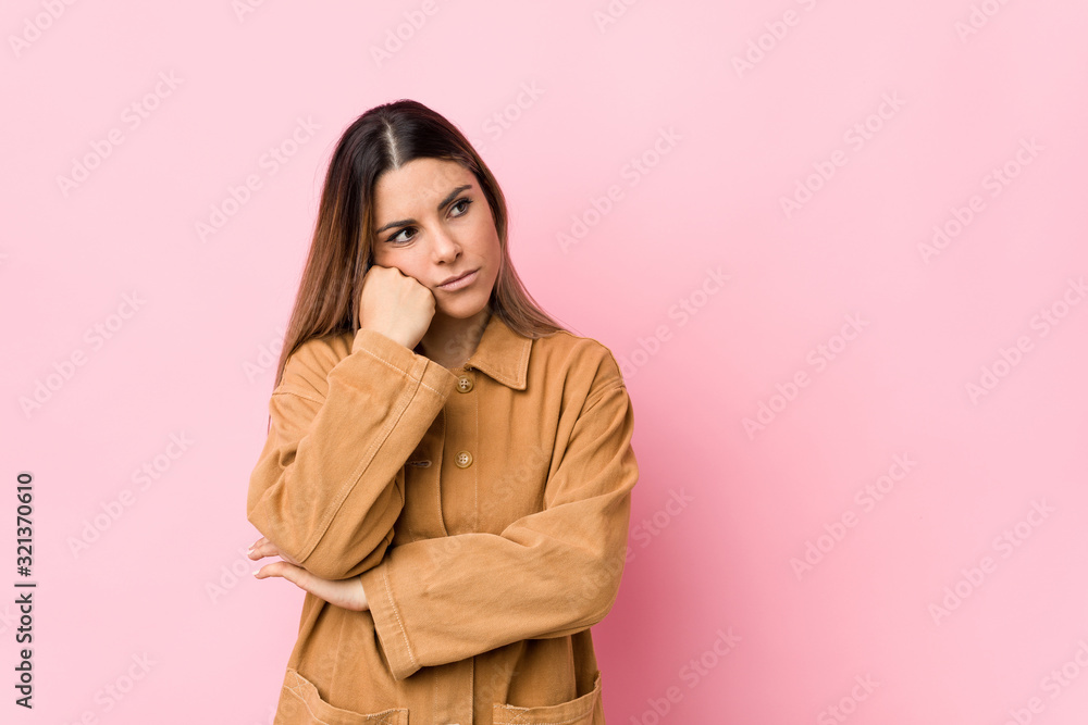 Young caucasian woman isolated who feels sad and pensive, looking at copy space. Young caucasian woman isolated who feels sad and pensive, looking at copy space.