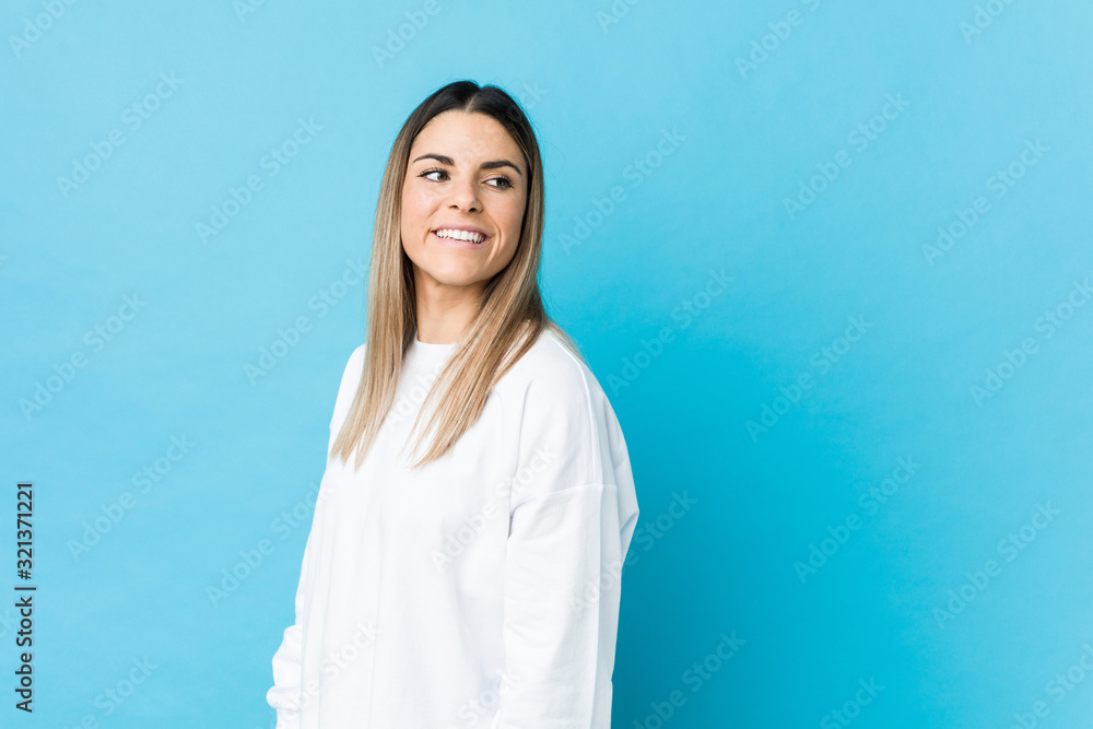 Young caucasian woman isolated looks aside smiling, cheerful and pleasant. Young caucasian woman isolated looks aside smiling, cheerful and pleasant.
