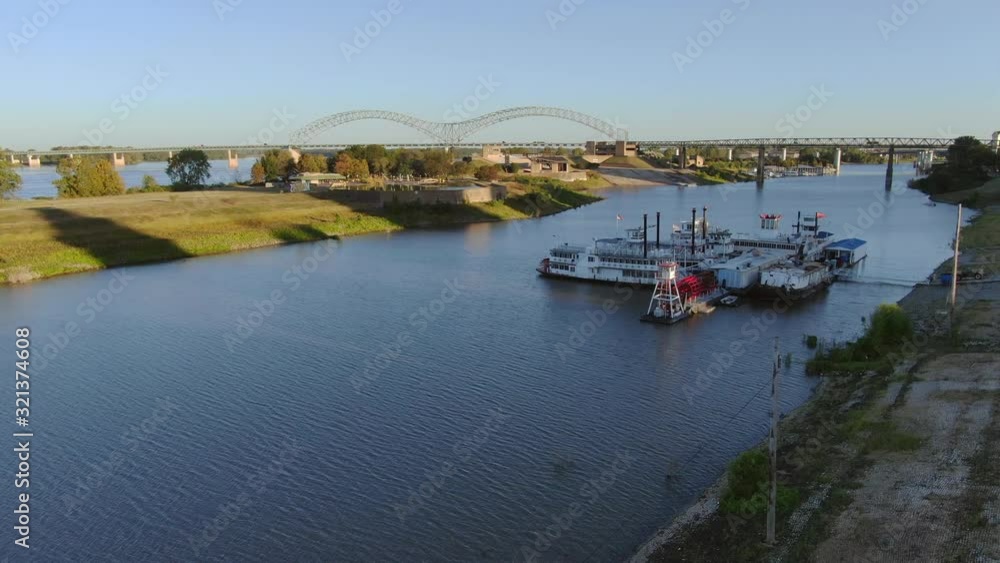 Paddle boats docked along Mississippi river inlet - low altitude aerial view during early morning sunrise Paddle boats docked along Mississippi river inlet - low altitude aerial view during early morning sunrise