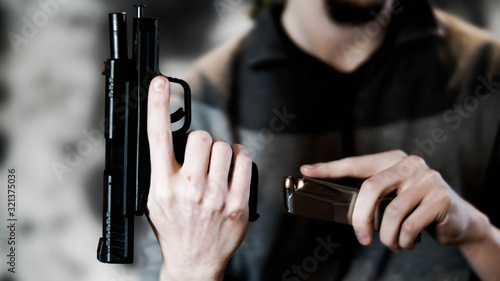 Man reloading a .45 caliber pistol with a dual-stacked magazine