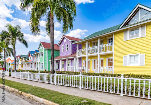 Typical dominican colorful wood houses, palm trees on an emblematic downtown street, Samana, Dominican Republic photo