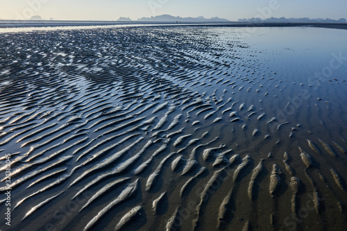 texture of wet sand on a beach during low tide.