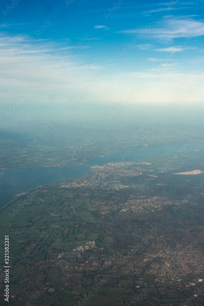 Amsterdam Schiphol,, a view of a large body of water with a mountain in the background