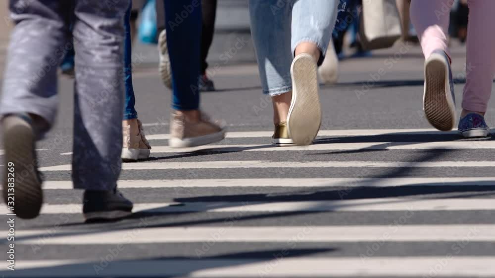 Legs of people walking on a crosswalk of a street - St. Petersburg, Russia Legs of people walking on a crosswalk of a street - St. Petersburg, Russia