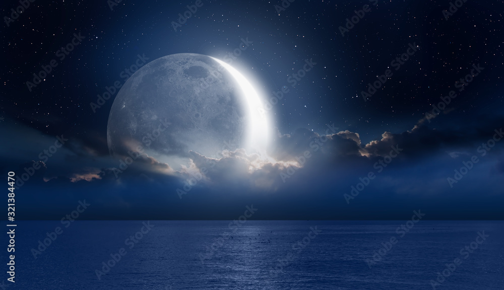Fototapeta Crescent moon over the tropical sea at night 