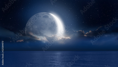 Fotografie, Obraz Crescent moon over the tropical sea at night Elements of this image furnished b