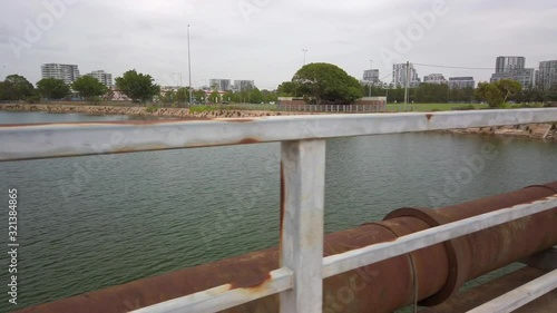 Corroded old water pipe and fench next to a river in Sydney, Australia photo