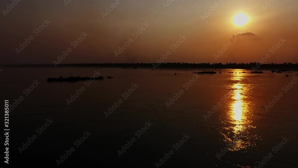 Beautiful Scenery Of The Bright Round Moon Reflecting On The Water Of Mekong River In Kompong Khleang, Cambodia - Wide Shot Beautiful Scenery Of The Bright Round Moon Reflecting On The Water Of Mekong River In Kompong Khleang, Cambodia - Wide Shot