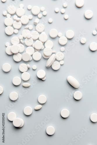 Fototapeta Naklejka Na Ścianę i Meble -  White pills on a blue background