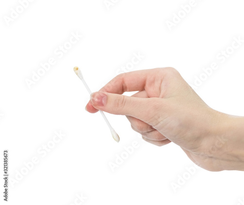 Hand holding a dirty cotton swab. Close up. Isolated on a white background