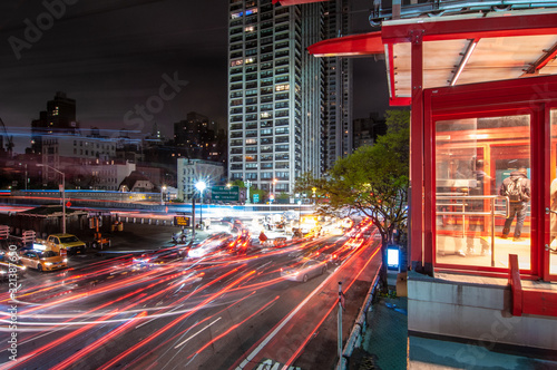 Photography Roosevelt Island Tram station at the end of the Ed Koch Queensboro bridge at night as the tram enters